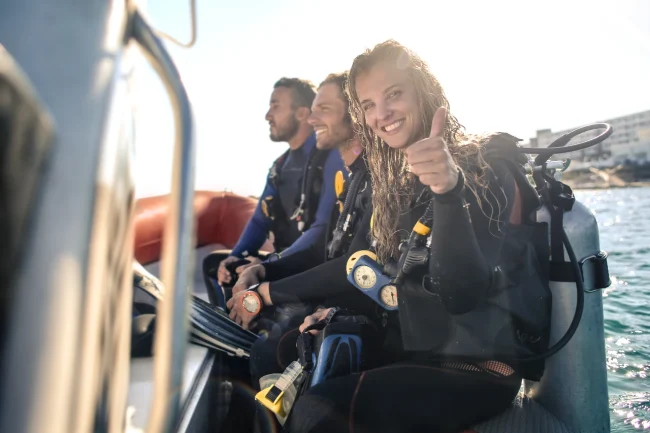 young diver giving thumbs up on dive boat in Fiji